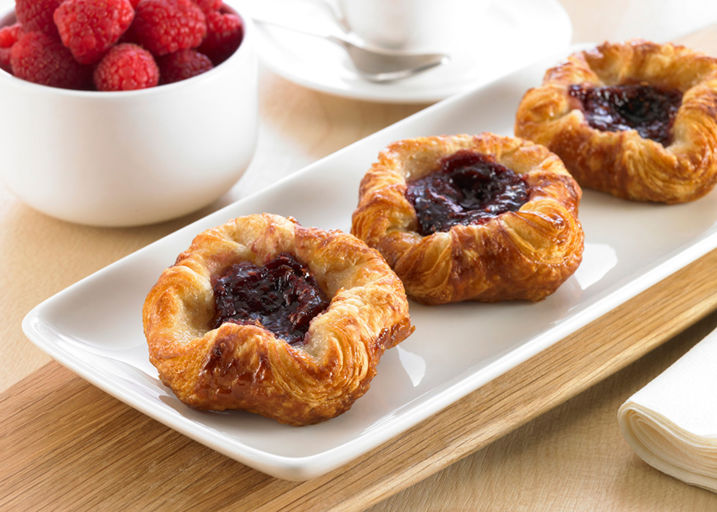 Schulstad Mini Raspberry Crown Danish Pastries with thick raspberry purée filling centered between 24 layers of pastry dough. Great for Breakfast Foodservice.