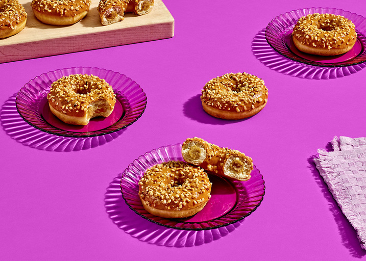 Schulstad Ready-to-Eat Caramel Filled Ring Donuts with silky caramel, topped with a velvety caramel glaze, and finished with a crunchy layer of roasted hazelnuts