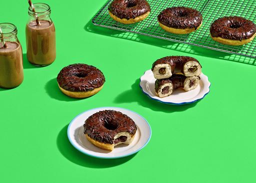 Ready-to-eat Chocolatey Filled Ring Donuts coated in a rich cocoa glaze and topped with cocoa sprinkles. Inside, a velvety smooth chocolatey filling awaits.