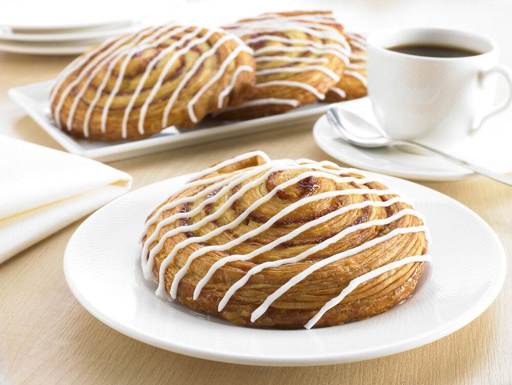 Schulstad Large Cinnamon Swirl Danish Pastries Plated and Served with Coffee