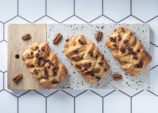 80242 Schulstad Mini Maple Pecan Plaits Served on a Board