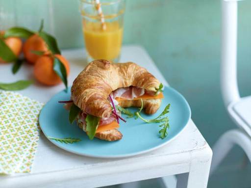 Schulstad Medium All-Butter Croissant Sandwich with prosciutto, arugula, cheese, and garlic aioli