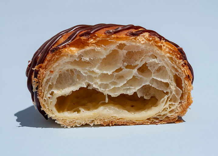 Schulstad Almond Danish Doughnut cut in half to show creamy almond remonce filling
