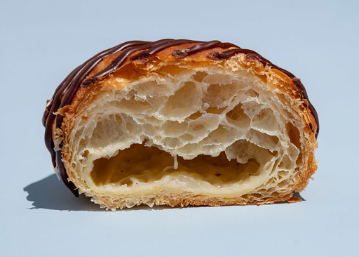 Schulstad Almond Danish Doughnut cut in half to show creamy almond remonce filling
